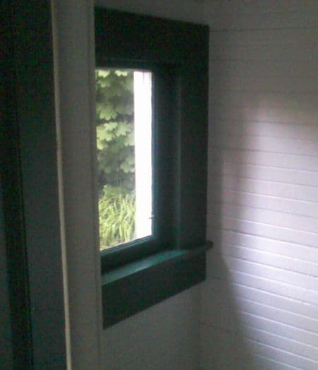 Pale daylight coming through a simple window into an empty painted room